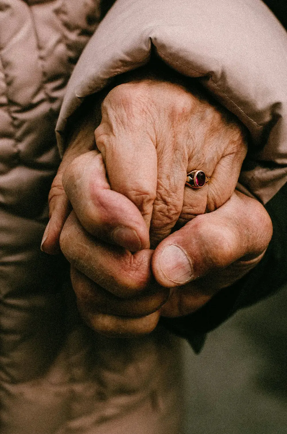 An older couple holding hands